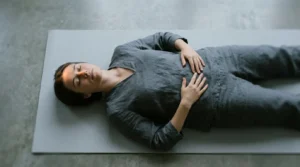 Person lying in savasana with subtle visual representation of the transitional state between wakefulness and sleep