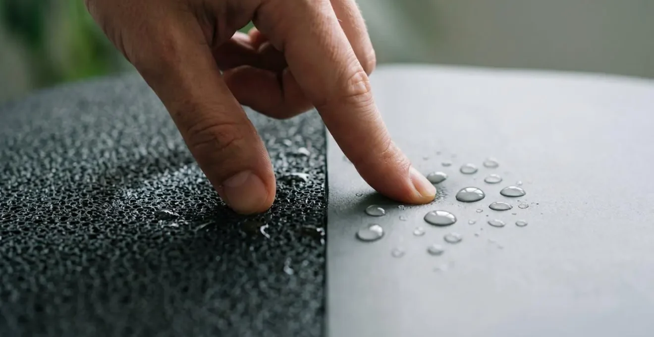 Hands and feet on yoga mat surface during hot yoga showing moisture beads and grip texture
