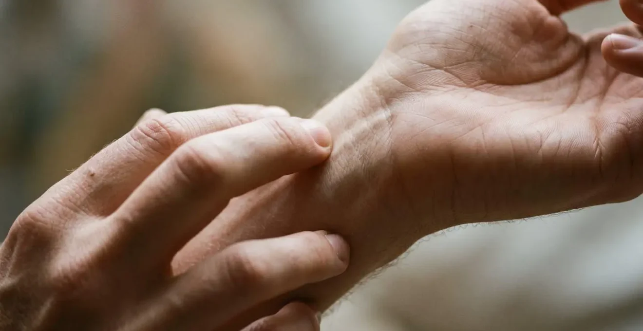 Close detail of hands in gentle exploratory movement against minimal background