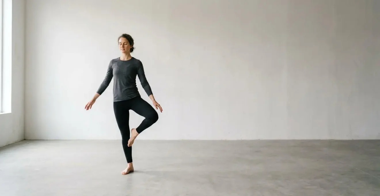 Person performing single-leg balance test with eyes closed in minimal environment