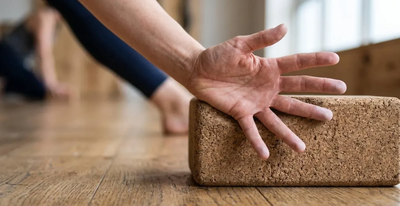 Close-up of hand pressing into yoga block during triangle pose showing active engagement