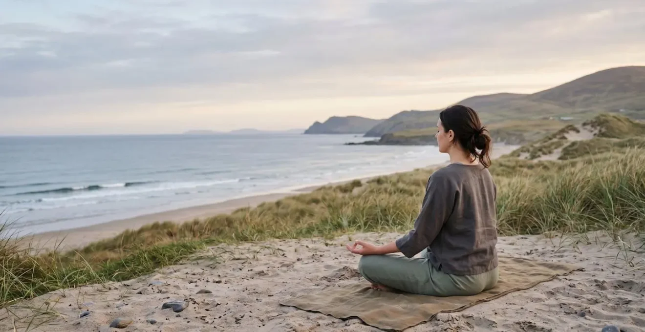 Environmental wide shot of person in contemplative yoga pose within serene natural setting emphasizing mind-body connection
